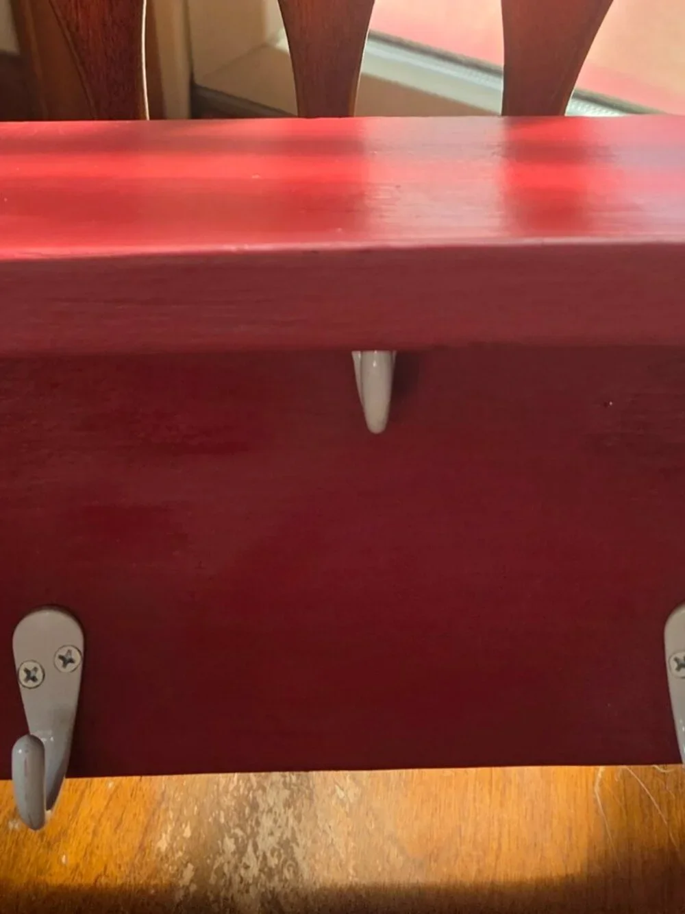 red wooden shelf with 5 hooks nice size has hooks on back to hang